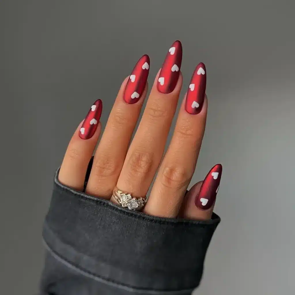 Bold Burgundy Nails with White Heart Design for a Dramatic Valentine's Day Look