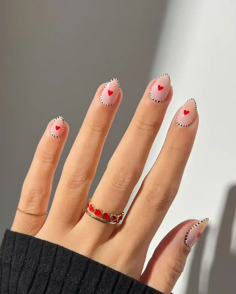 Modern Pale Pink Nails with Dotted Border and Tiny Red Hearts for Romantic Vibes