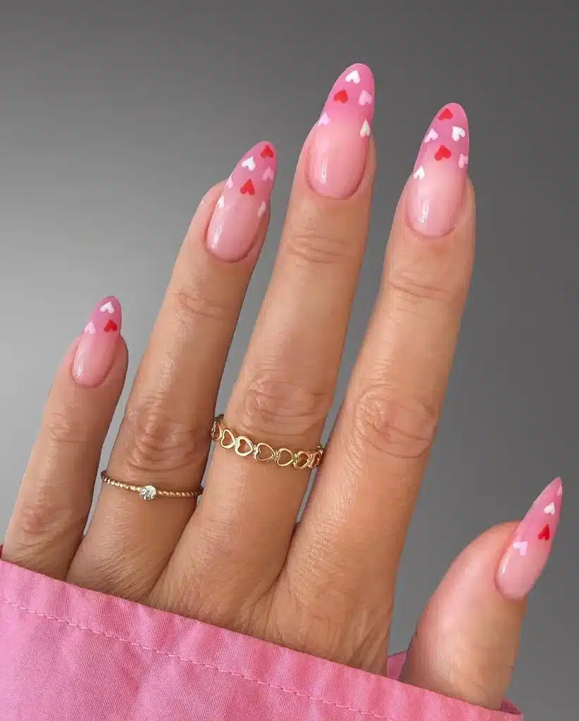 Gradient Pink and Red Heart Nails Cascading Down Nude Nails for Sweet Valentine's Look