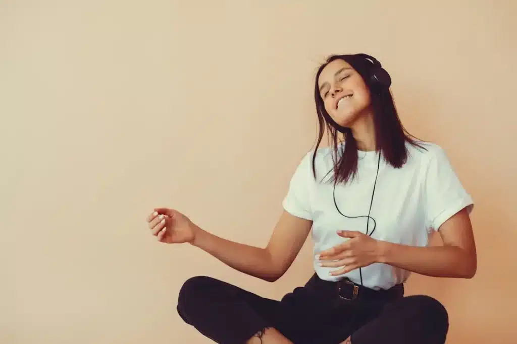 Person taking movement break dancing to music for midday self-care