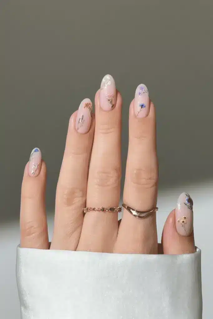Pressed Flower Fantasy nail design featuring delicate real pressed flowers encapsulated in a clear base for an ethereal, nature-inspired look.