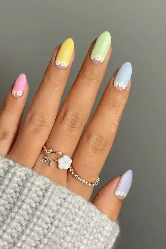 Rainbow Daisy Dreams nail design featuring vibrant rainbow colors and delicate daisy floral patterns for a cheerful, playful look.