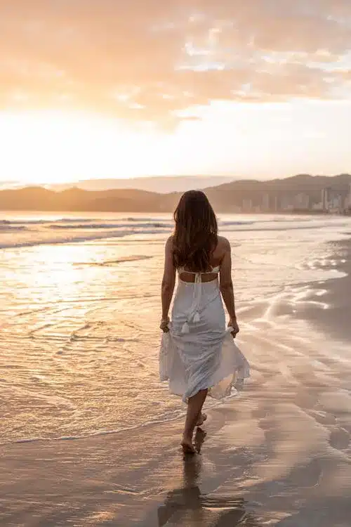 Person walking during golden hour sunset for evening self-care ritual