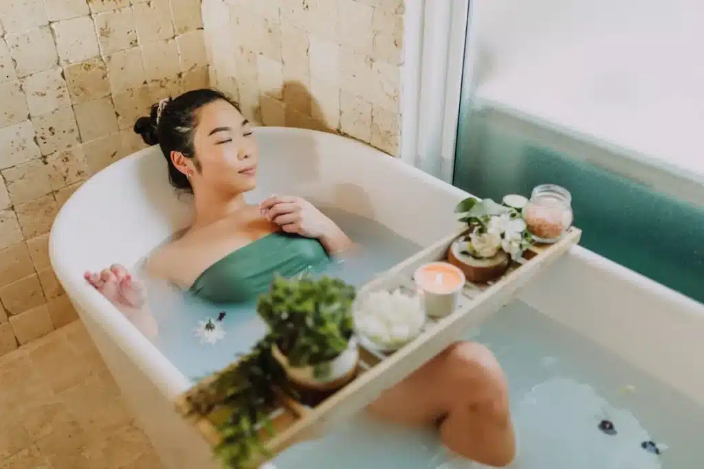 Bathroom transformed with candles and bath products for home spa night