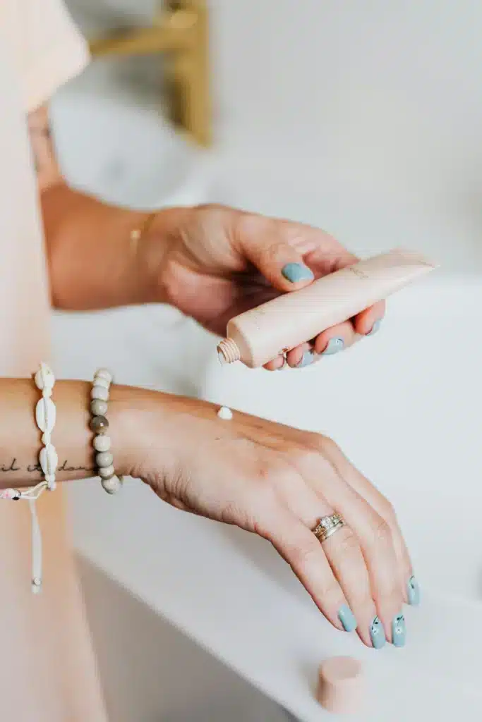 Person applying luxury hand cream as sensory self-care ritual at desk